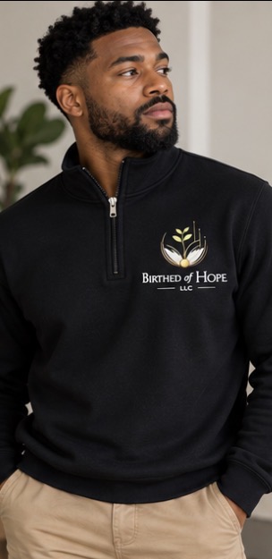 Model wearing the black Birthed of Hope LLC quarter zip, front view