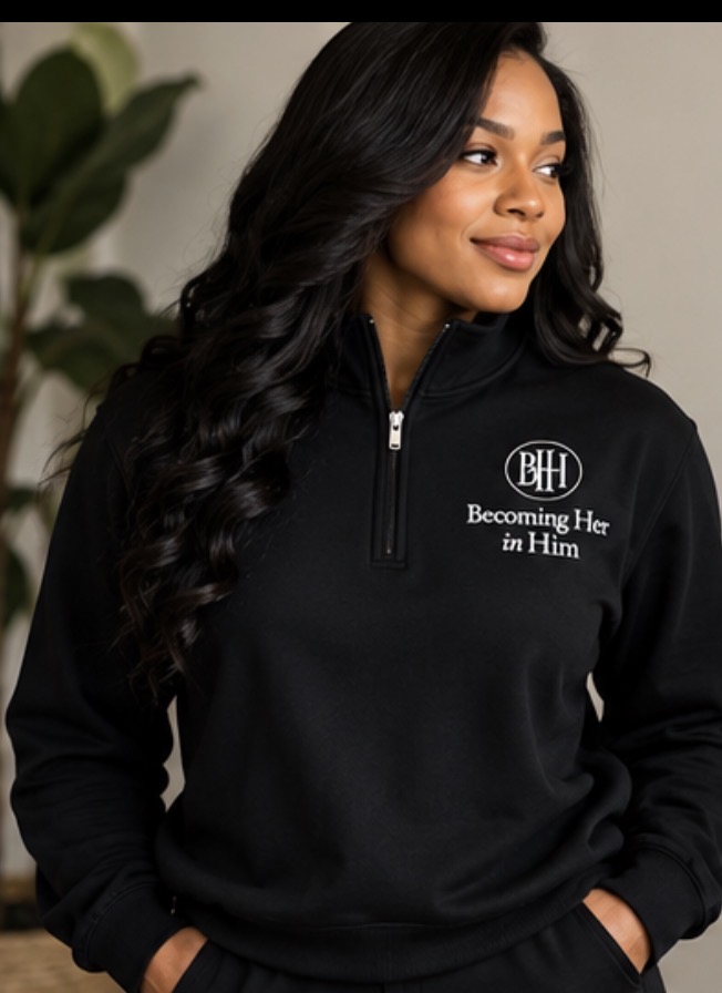 Model wearing the black Becoming Her in Him quarter zip, close-up front view